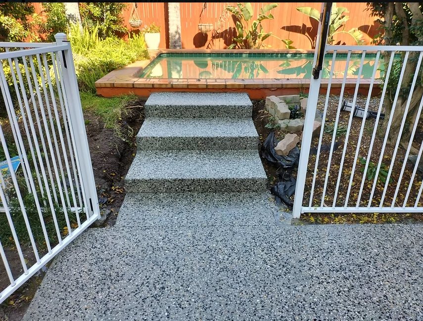 Exposed aggregate steps leading to a pool gate
