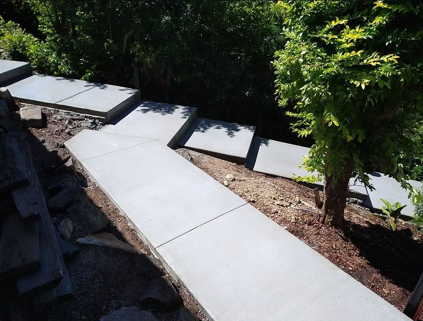 Stepped concrete path down a sloping garden