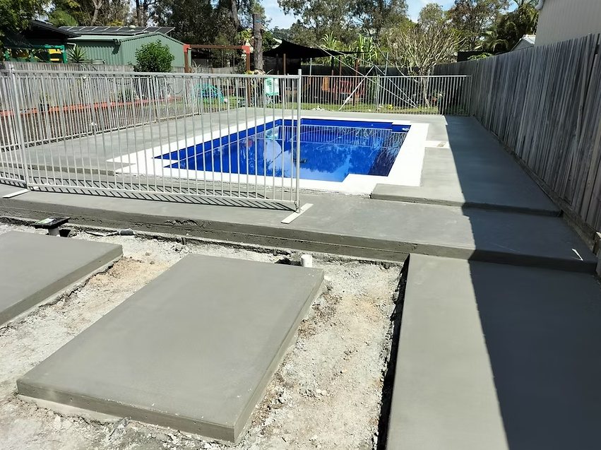 Freshly poured concrete around a pool